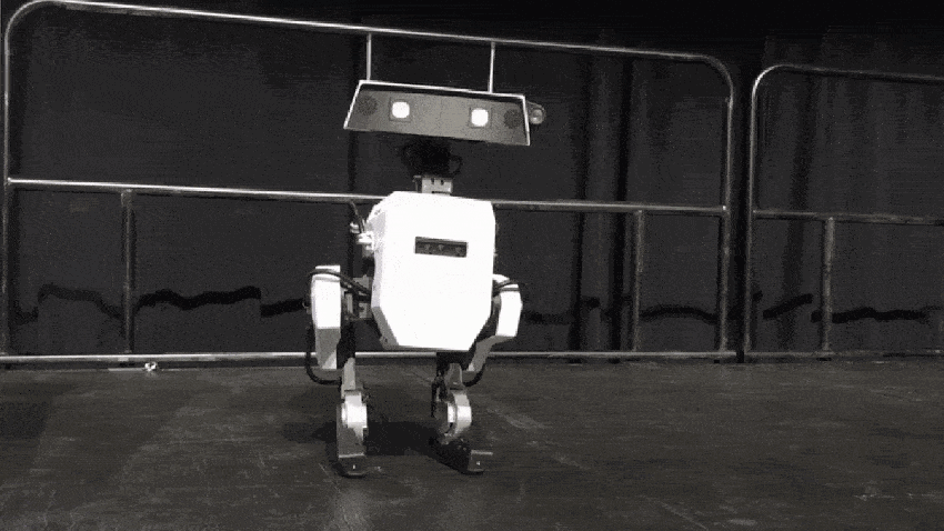 A small robot is dancing on a stage