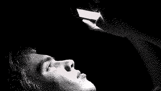 A person lying down in the dark, looking at a smartphone held above their face, scrolling through social media.