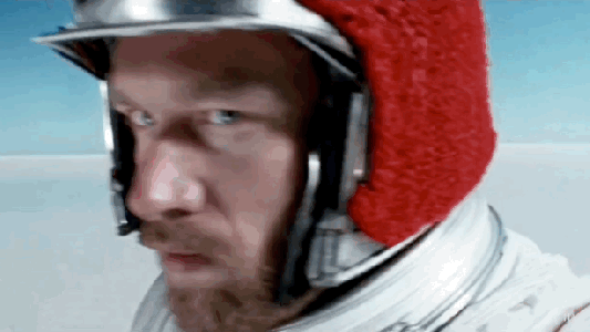 A man in a spacesuit with a red helmet designed by Sora.