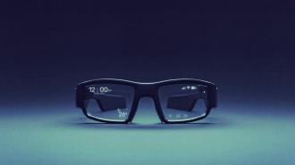 A pair of black smart glasses with a digital display showing the time, temperature, and icons on the lenses against a blue gradient background.