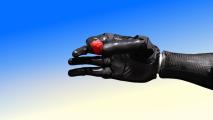 A black robotic hand holding a small red object against a blue and beige gradient background.