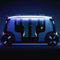 A futuristic car is shown in a dark room.