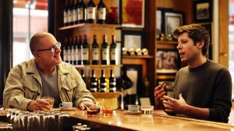Two men sit at a bar counter having a conversation. Bottles and glasses line the shelves in the background. One man gestures while speaking about OpenAI; the other listens intently, holding his drink.