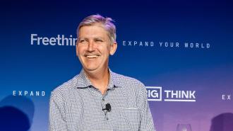 A man with gray hair and a mustache sits smiling in front of a blue background with "Freethink" and "Big Think" logos.