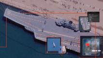 Satellite view of an aircraft carrier docked at a port, with inset images showing maps, close-ups, and a highlighted red area.